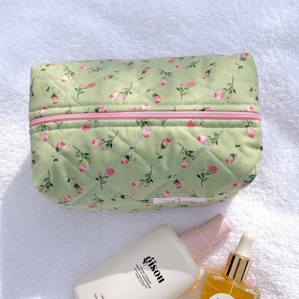 Mint green rose floral pouch with long pink zipper across the front
