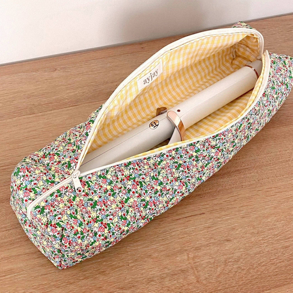 Floral zippered pouch bag with yellow check lining, open showing cream interior