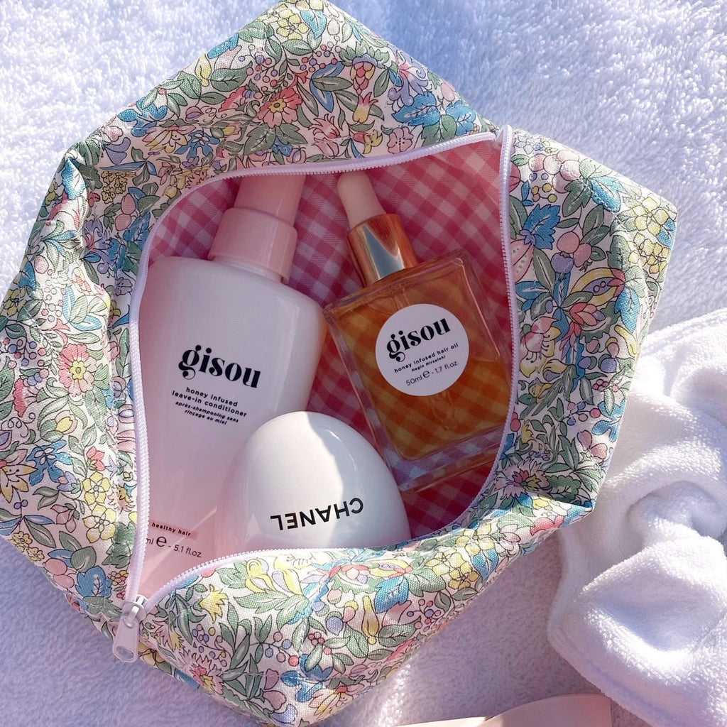 Floral zip pouch with multicolor flower print and pink gingham lining, open top