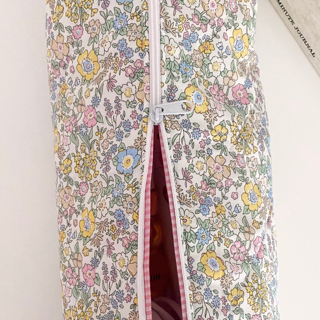 Floral zip pouch with pink piping and side pocket, open view of storage lining