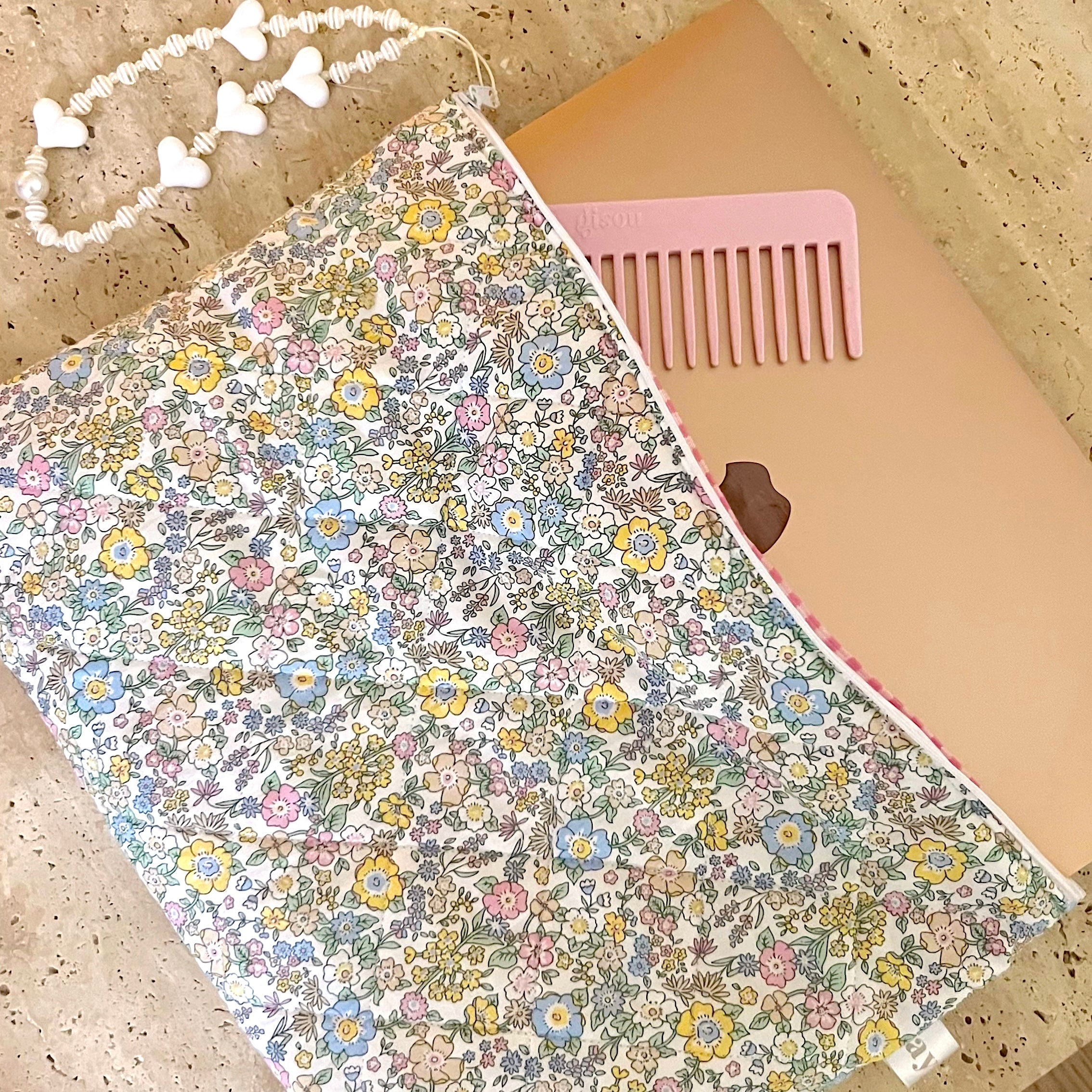 Floral vintage laptop sleeve with pink comb-style trim and light backing view