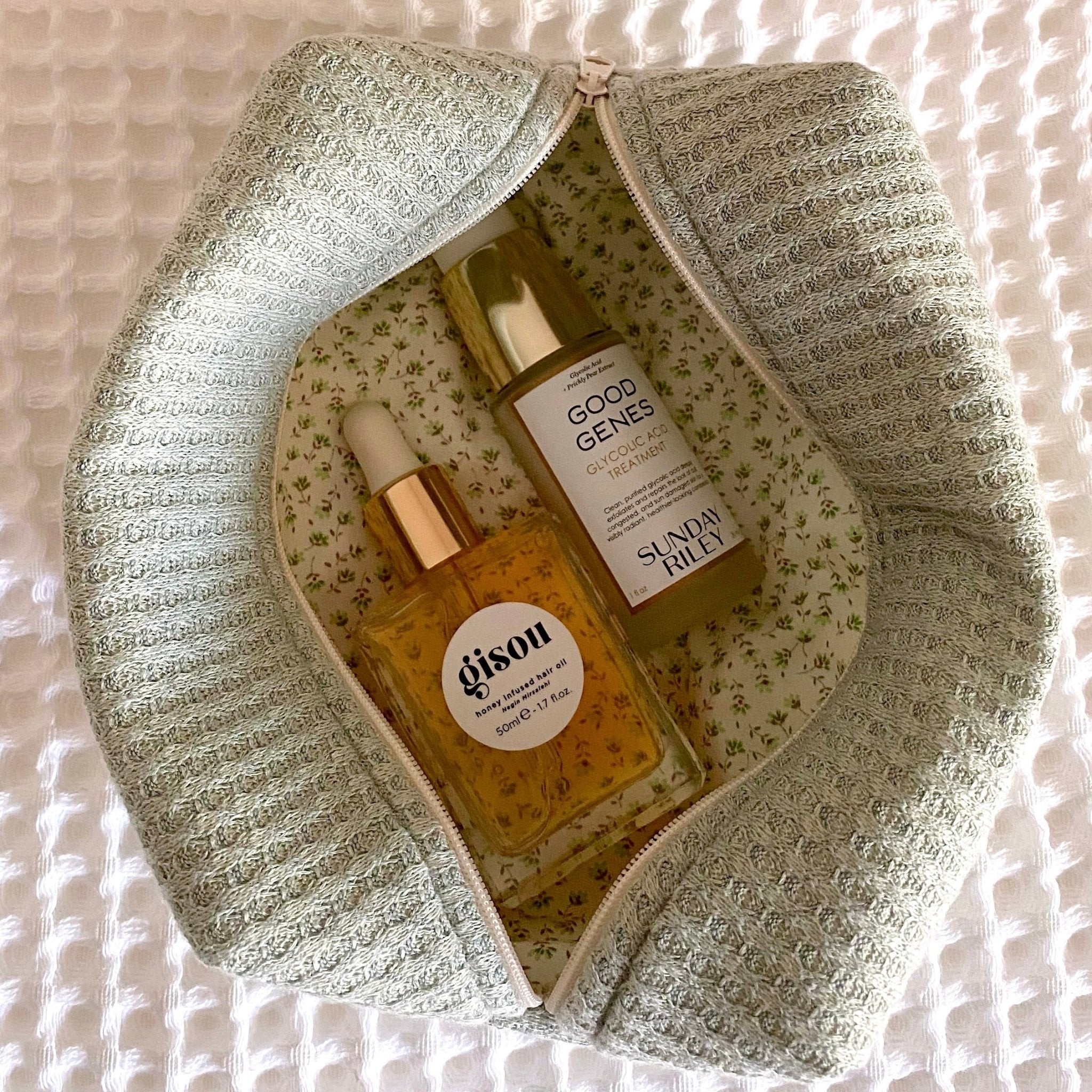 Sage green waffle knit zip pouch, open view with floral inner fabric.