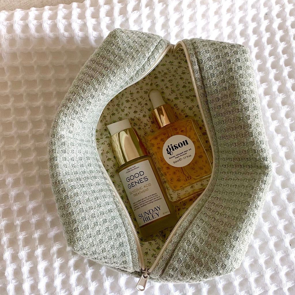 Jade waffle knit zip pouch, sage green texture with floral patterned inner lining.