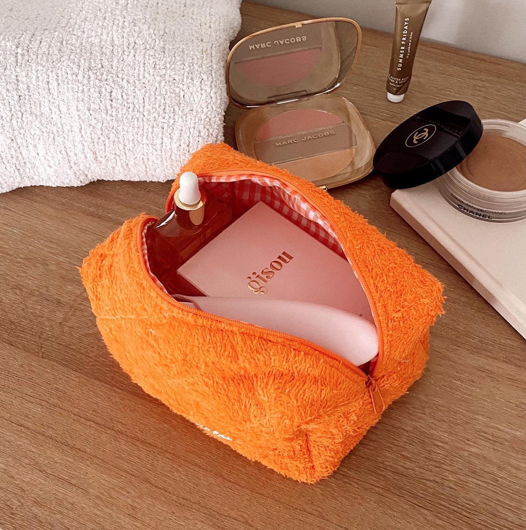 Orange teddy fabric mini zip pouch, open top with plaid lining and inner pocket