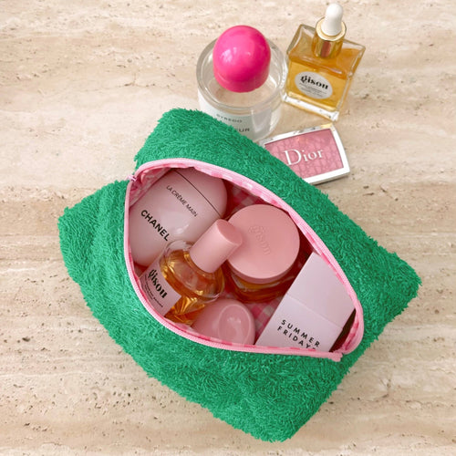 Parakeet green terrycloth pouch with pink-lined opening and zipper trim, shown open