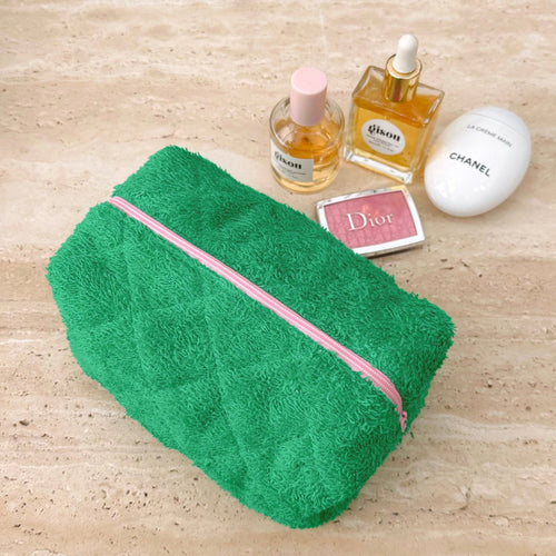 Parakeet green terrycloth pouch with pink zipper stripe, shown closed