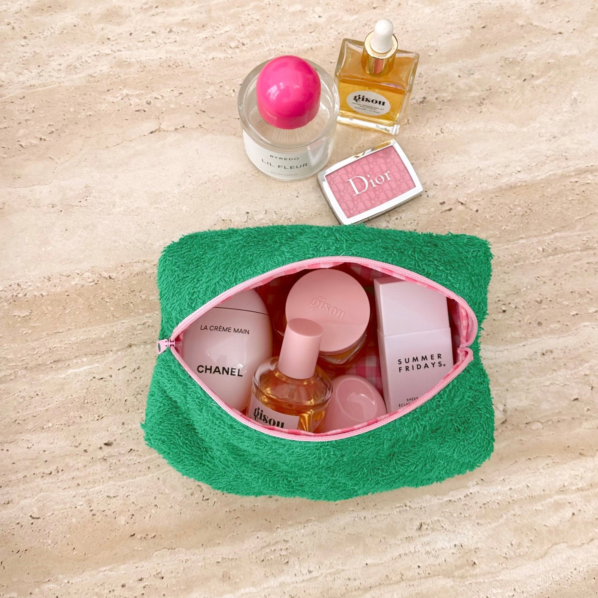 Parakeet green terrycloth pouch with pink-lined opening and zipper trim, shown open