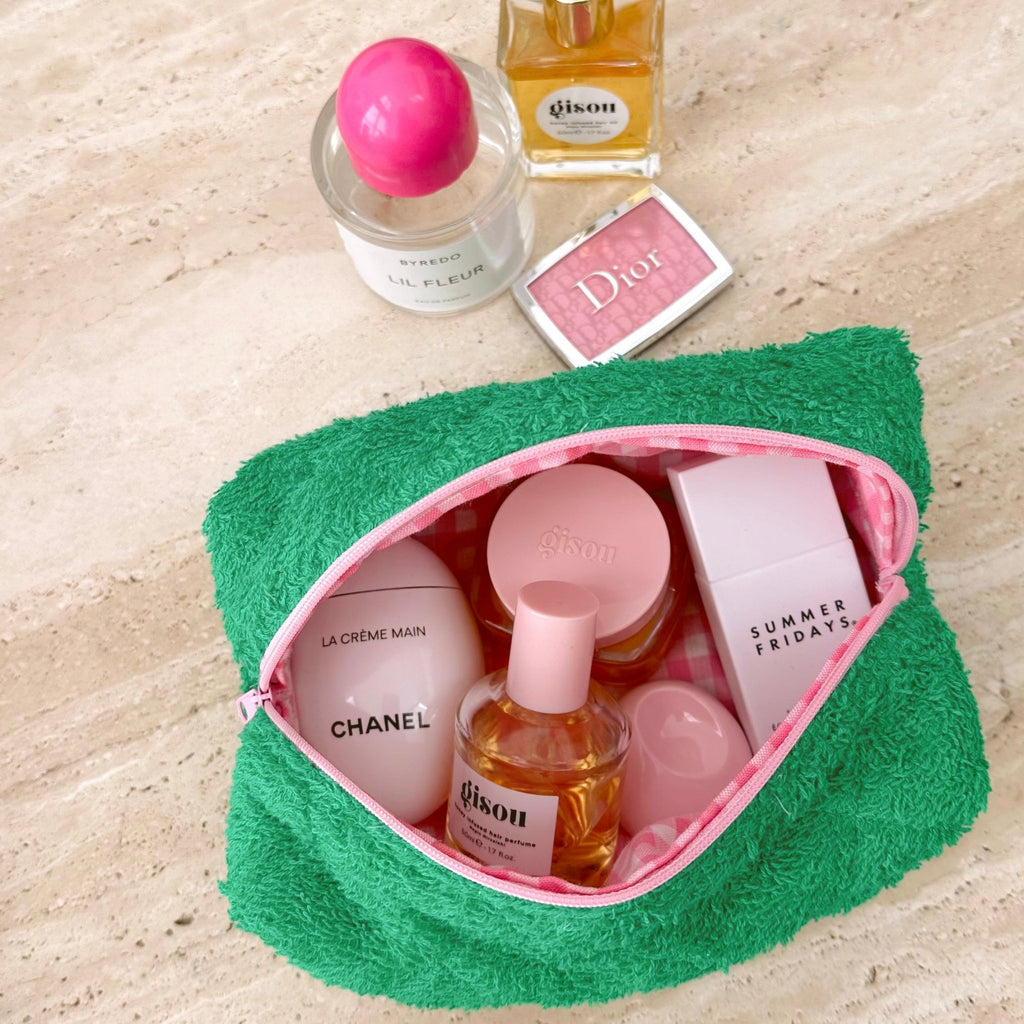 Parakeet green terrycloth pouch with pink zipper trim and pink-lined interior, shown open