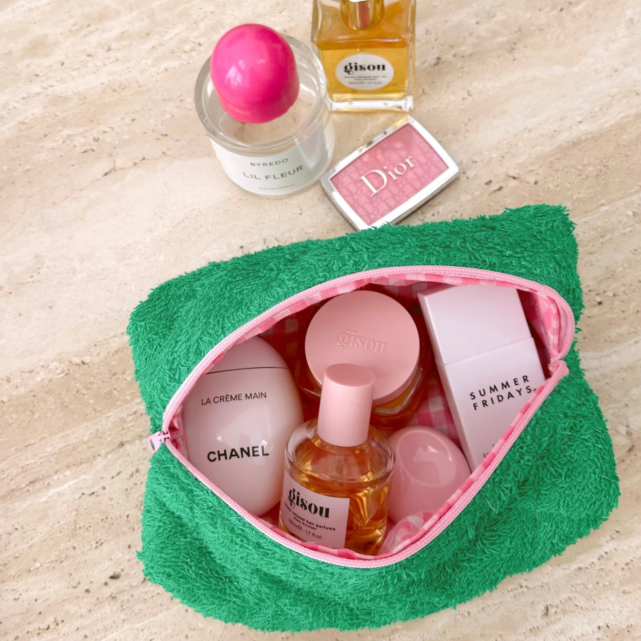 Parakeet green terrycloth pouch with pink zipper trim and pink-lined interior, shown open