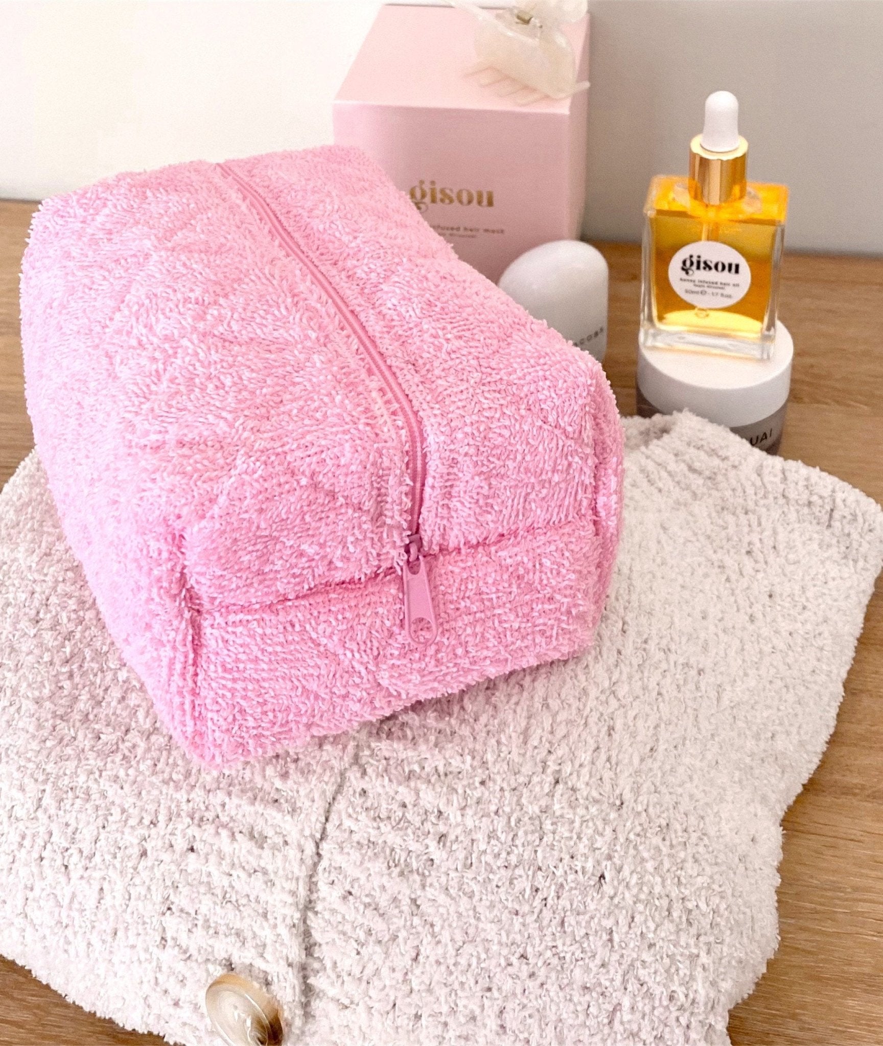 Pink terrycloth gingham pouch with pink zipper, partially open view