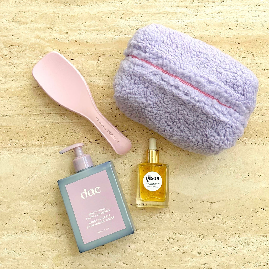 Lavender plush teddy pouch with pink zipper and smooth curved shape