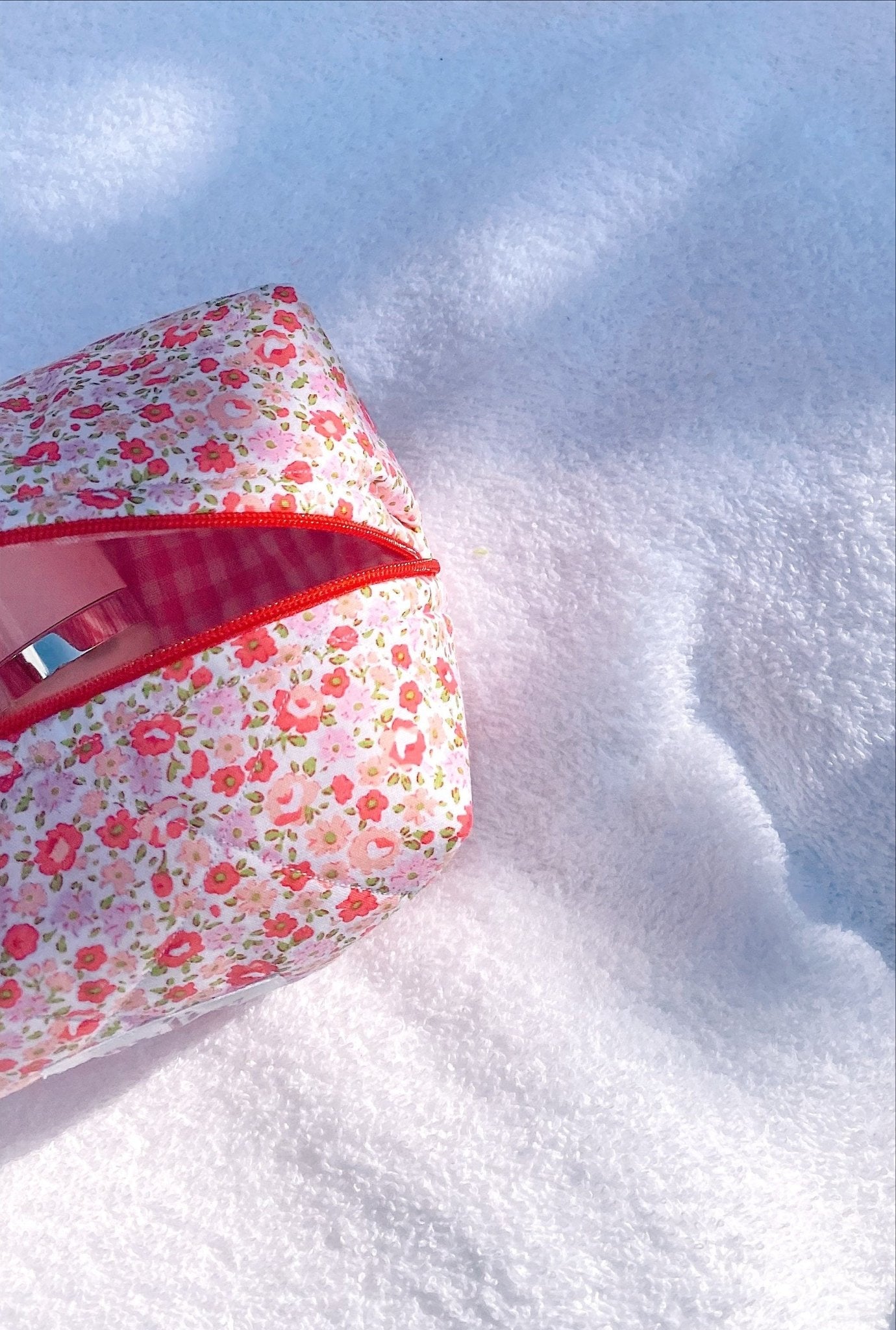 Floral pouch side profile with red zipper trim and pink gingham interior