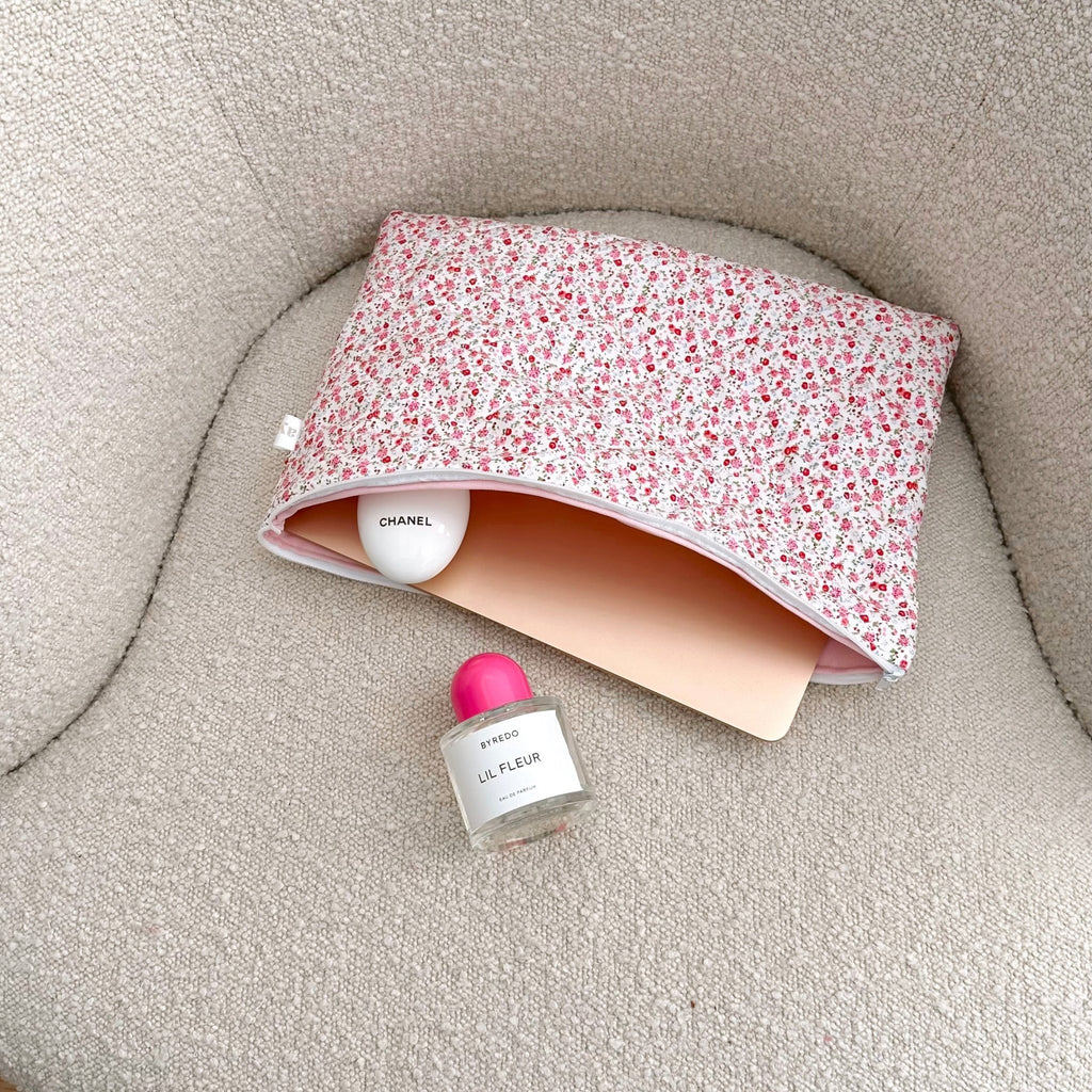 Red floral zip pouch with curved opening and pink lining; flat makeup storage bag