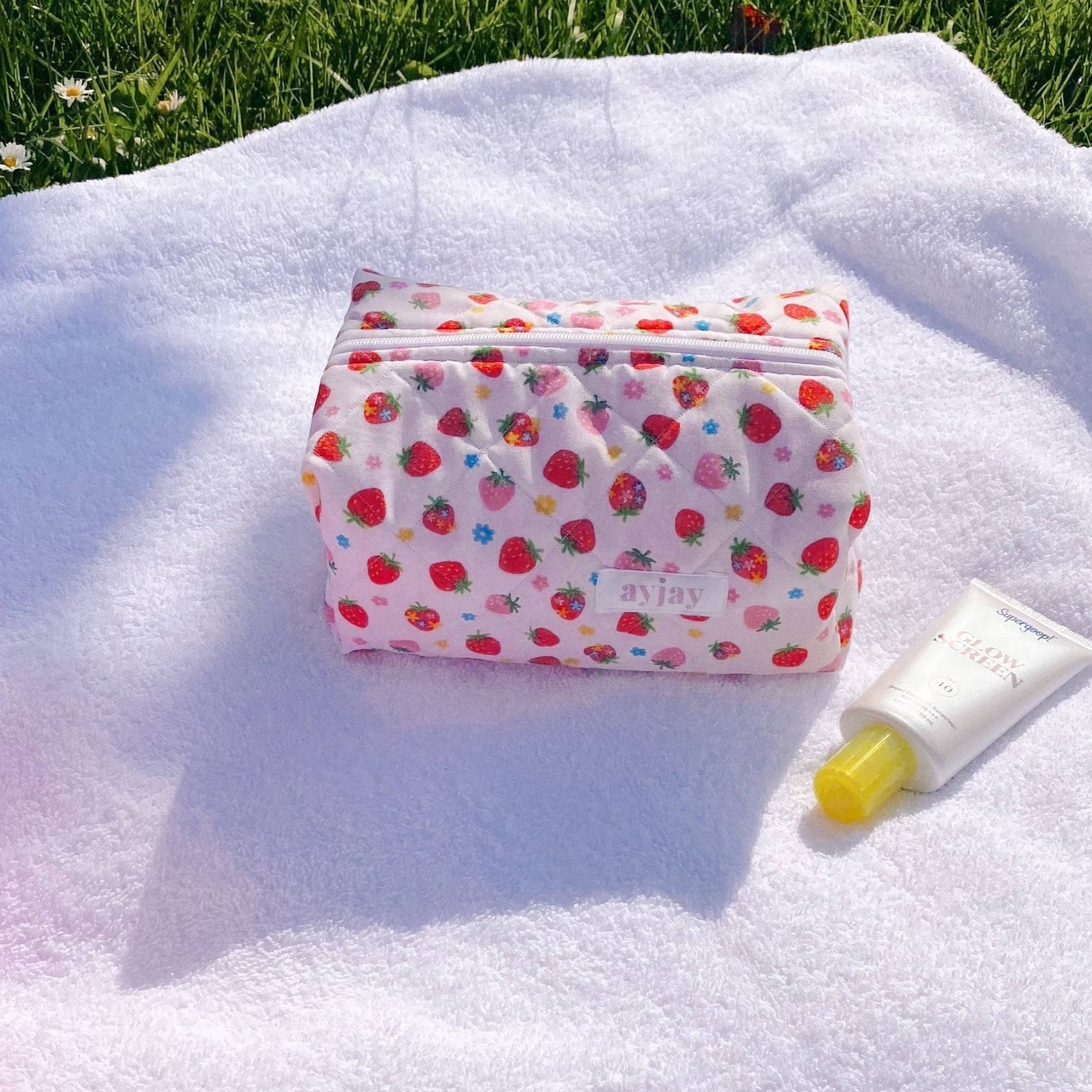 Strawberry floral zip pouch with strawberry print, folded top and stitched seams