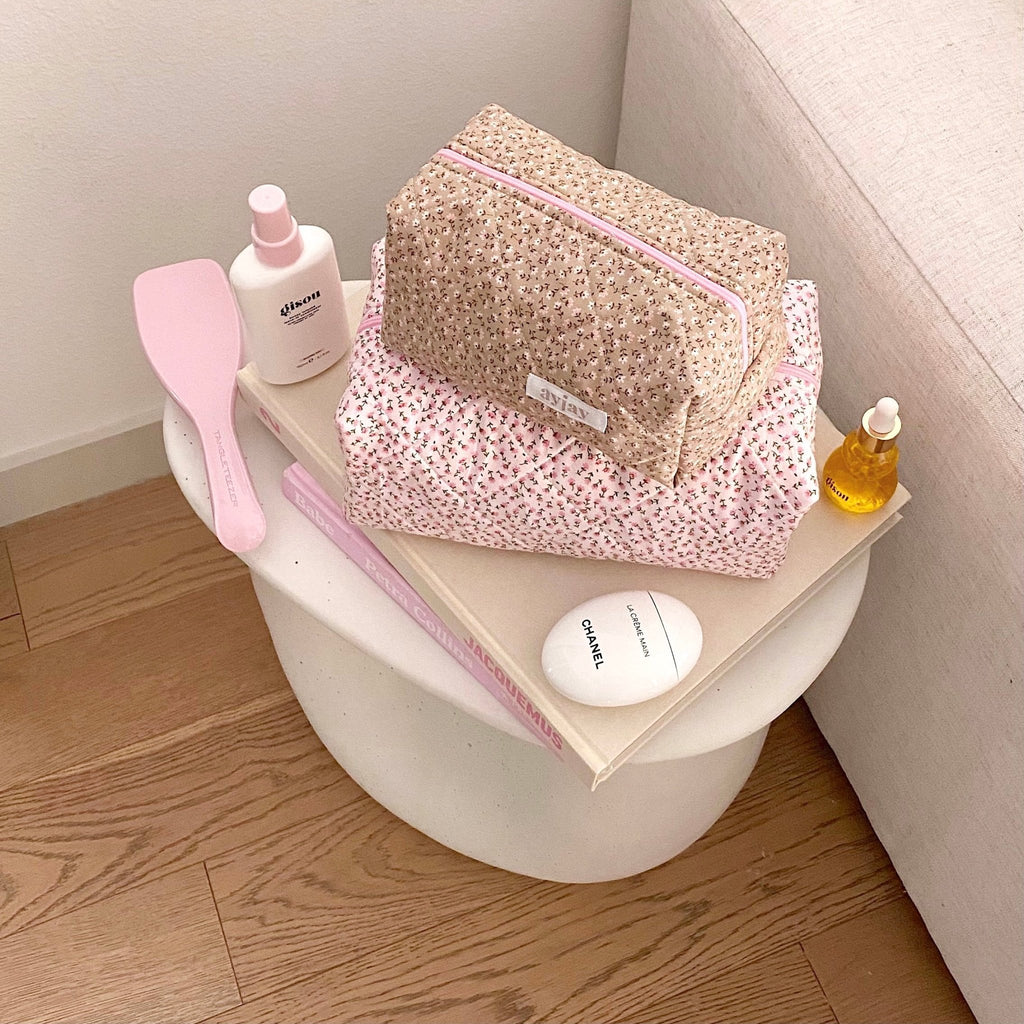 Tan floral cosmetic bag with pink zipper trim, open pouch showing bottles inside