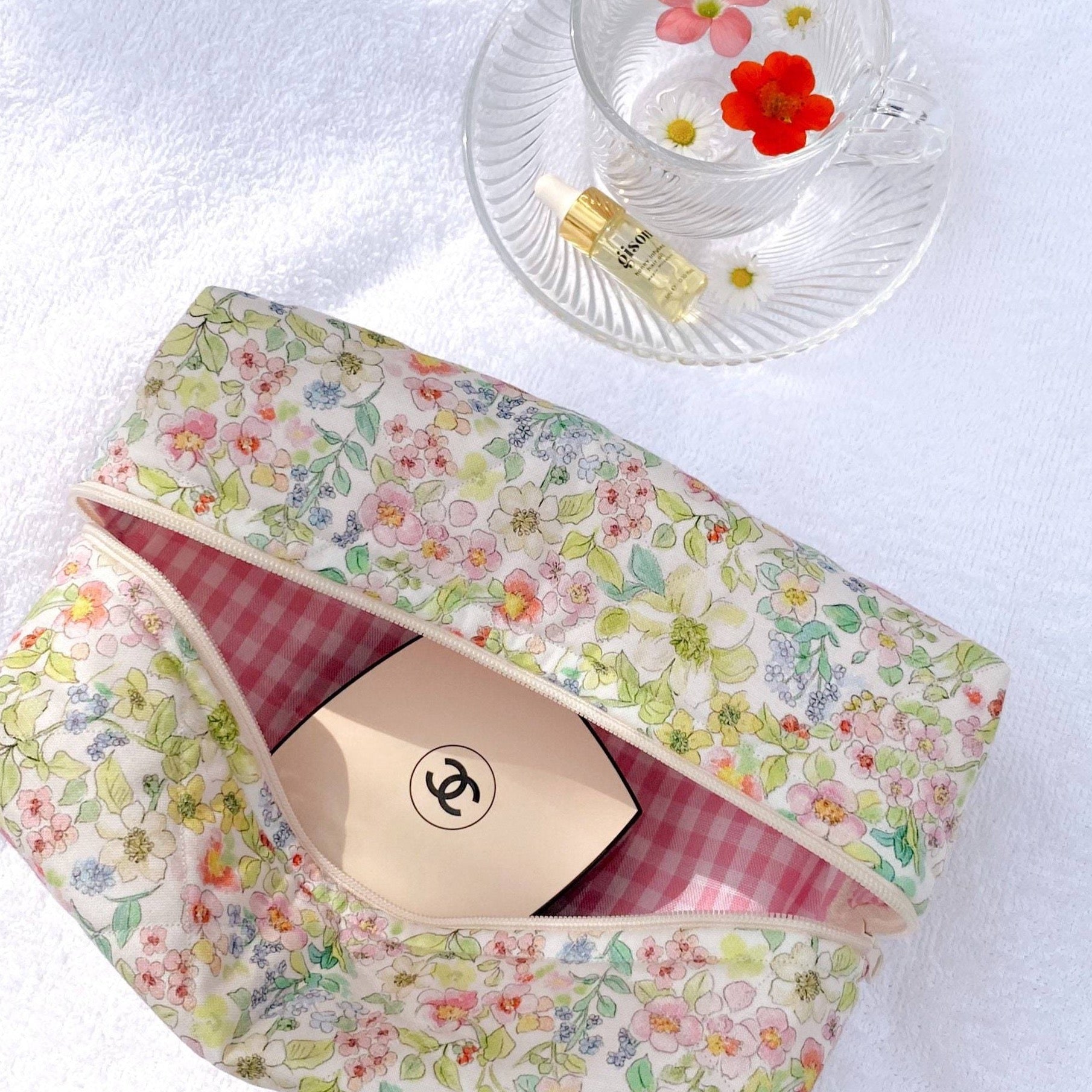 Floral zip pouch with pale green multicolor flowers and pink gingham lining, open