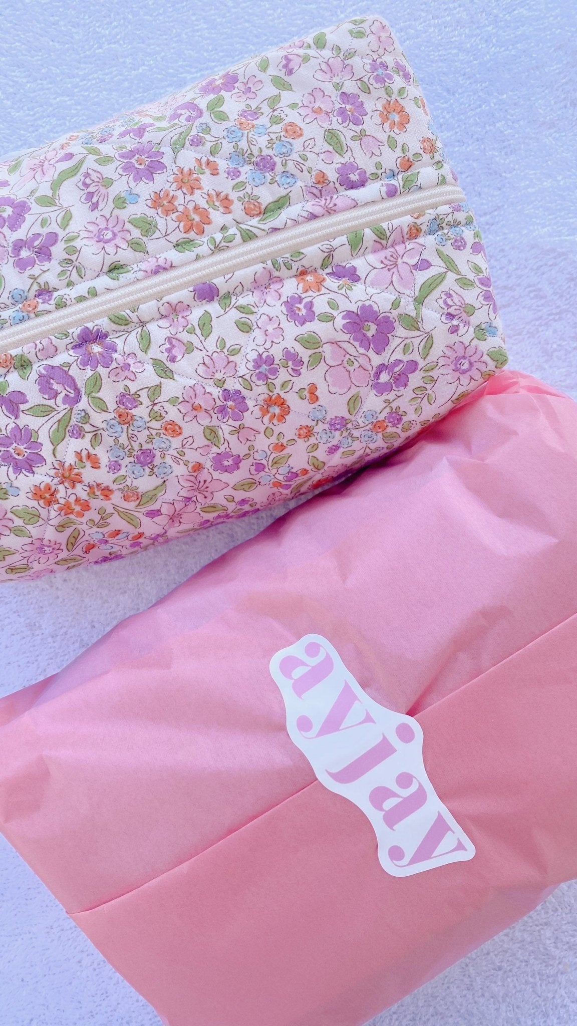 Floral zip pouch exterior detail with zipper and colorful flower pattern on pale fabric