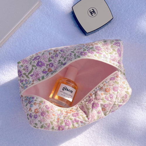 Vintage purple floral zip pouch, open top with interior lining and small bottle inside