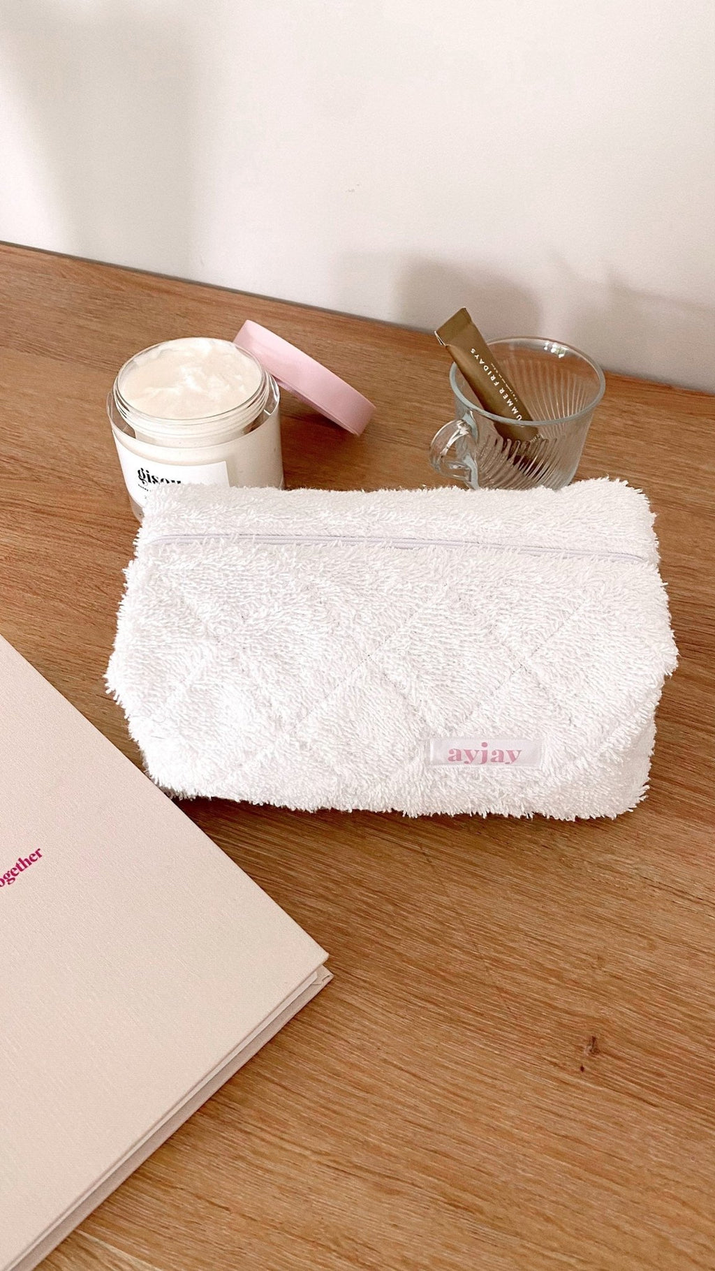 White terrycloth pouch with horizontal zip, front panel visible